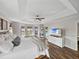 Spacious main bedroom featuring a tray ceiling, wood floors, and pool view at 1301 Hidden Creek Ct, Winter Haven, FL 33880