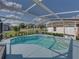 The pool is set in a screened enclosure with chairs on the deck, giving views of the backyard at 1301 Hidden Creek Ct, Winter Haven, FL 33880