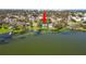 Lakefront property featuring a home with a private dock, surrounded by lush greenery and scenic water views at 14 Lake Hollingsworth Dr, Lakeland, FL 33803