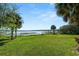 Expansive backyard with lush green grass and a lovely waterfront view at 14 Lake Hollingsworth Dr, Lakeland, FL 33803