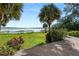 Lush backyard with manicured lawn and dock overlooking scenic water view at 14 Lake Hollingsworth Dr, Lakeland, FL 33803