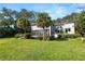 Daytime exterior shot of the home featuring a modern design, large windows, and well-maintained landscaping at 14 Lake Hollingsworth Dr, Lakeland, FL 33803