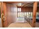 Interior shot of the home showing the wooden walls, staircase, and floor-to-ceiling windows at 14 Lake Hollingsworth Dr, Lakeland, FL 33803