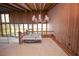 View of the living room's upper level with a unique tub feature and wood paneling, highlighting potential at 14 Lake Hollingsworth Dr, Lakeland, FL 33803