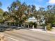 Street view of home with large trees and lake views in Lakeland Florida at 14 Lake Hollingsworth Dr, Lakeland, FL 33803