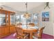 Bright dining room with a round table, cabinet, and large windows providing natural light at 140 Jackson Park Ave, Davenport, FL 33897