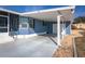 Exterior view of the blue home, showcasing the covered parking and a clean driveway, with a hint of the surrounding landscape at 140 Jackson Park Ave, Davenport, FL 33897