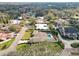 Aerial view of home featuring a pool and a meticulously maintained lawn in a desirable neighborhood at 1401 Easton Dr, Lakeland, FL 33803