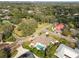 Aerial view of a home featuring a pool and manicured backyard, nestled in a lush, tree-filled neighborhood at 1401 Easton Dr, Lakeland, FL 33803