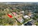 Aerial view of a home featuring a pool and manicured backyard, nestled in a lush, tree-filled neighborhood at 1401 Easton Dr, Lakeland, FL 33803