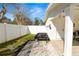 A grassy backyard with a grill and a white fence at 1401 Easton Dr, Lakeland, FL 33803