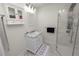 Bright bathroom featuring a marble-top vanity and modern walk-in shower with multi-jet system at 1401 Easton Dr, Lakeland, FL 33803