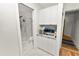 Hallway with vanity, stainless steel ice maker and a modern bathroom with shower in the background at 1401 Easton Dr, Lakeland, FL 33803