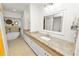 Bathroom featuring granite countertops, double vanity, soaking tub and modern fixtures creating a spa-like retreat at 1401 Easton Dr, Lakeland, FL 33803