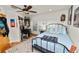 Bedroom with a fan, hardwood floors, window, light blue bedspread, and a gray patterned area rug at 1401 Easton Dr, Lakeland, FL 33803