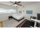 Well-lit bedroom featuring a ceiling fan, large window, and a workspace with computer at 1401 Easton Dr, Lakeland, FL 33803