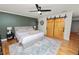 Charming bedroom featuring stylish ceiling fan, barn door closet and tranquil green accent wall for relaxation at 1401 Easton Dr, Lakeland, FL 33803