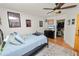 Bedroom with hardwood floors, ceiling fan, blue and white bedspread, closet, and TV at 1401 Easton Dr, Lakeland, FL 33803