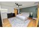 Charming bedroom features stylish ceiling fan, barn door closet and tranquil green accent wall for relaxation at 1401 Easton Dr, Lakeland, FL 33803