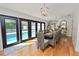 Elegant dining area with pool view through French doors and stylish chandelier at 1401 Easton Dr, Lakeland, FL 33803