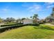 Landscaped front yard with lush lawn, mature trees, a basketball hoop, and neatly trimmed hedges enhances curb appeal at 1401 Easton Dr, Lakeland, FL 33803