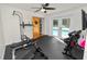 Home gym with free weights, weight bench and access to french doors leading to the pool area at 1401 Easton Dr, Lakeland, FL 33803