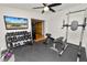 Home gym featuring workout equipment, a mounted TV, and rubber flooring perfect for fitness enthusiasts at 1401 Easton Dr, Lakeland, FL 33803