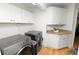 Modern laundry room with front-load washer and dryer, stylish flooring and white cabinets at 1401 Easton Dr, Lakeland, FL 33803