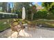 Wicker chairs and an umbrella create a comfortable outdoor seating area at 1401 Easton Dr, Lakeland, FL 33803