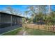 Fenced backyard features play set, trampoline, and access to screened patio at 1632 Sims Pl, Lakeland, FL 33803