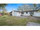 View of the backyard features a picnic table, mature landscaping, and a well-kept lawn at 1632 Sims Pl, Lakeland, FL 33803