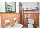 Cozy bathroom featuring a pedestal sink, shower, toilet, and unique tile work at 1632 Sims Pl, Lakeland, FL 33803