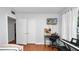 Bright bedroom featuring a study desk, wood floors, and closet at 1632 Sims Pl, Lakeland, FL 33803