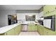 Bright kitchen with stainless steel appliances, light green cabinets, and ample counter space at 1632 Sims Pl, Lakeland, FL 33803