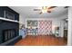 This living room offers laminate flooring, a fireplace and a wall-mounted television at 1632 Sims Pl, Lakeland, FL 33803