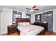 Comfortable main bedroom featuring a ceiling fan, hardwood floors, and dark wood furnishings at 1632 Sims Pl, Lakeland, FL 33803