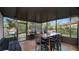 This covered patio offers a ceiling and screened walls with views of the backyard at 1632 Sims Pl, Lakeland, FL 33803