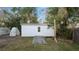 Exterior view of the white shed in the backyard with a concrete pathway at 1632 Sims Pl, Lakeland, FL 33803