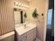 Bathroom with a large mirror, sink, and striped wallpaper at 1880 N Crystal Lake Dr # 28, Lakeland, FL 33801