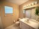 Bathroom featuring striped wallpaper, and a large mirror above the sink at 1880 N Crystal Lake Dr # 28, Lakeland, FL 33801