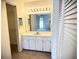 Bathroom vanity with light cabinets and hall access at 1880 N Crystal Lake Dr # 28, Lakeland, FL 33801