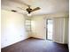 Bedroom featuring carpet flooring, ceiling fan and sliding glass doors at 1880 N Crystal Lake Dr # 28, Lakeland, FL 33801