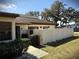 A bright home exterior featuring a neat lawn and a private stucco patio wall at 1880 N Crystal Lake Dr # 28, Lakeland, FL 33801