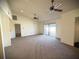 Open living room with vaulted ceilings, ceiling fans, carpet flooring and sliding glass doors at 1880 N Crystal Lake Dr # 28, Lakeland, FL 33801