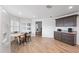 Open dining area features wood-look tile floors and matching cabinets with granite countertop at 1957 Prairie Dunes N Cir, Lakeland, FL 33810