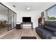 Living area with tile floors, television, and recliner at 1957 Prairie Dunes N Cir, Lakeland, FL 33810