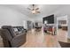 Open living room shows tile floors, neutral walls, contemporary furniture, and open access to dining and kitchen at 1957 Prairie Dunes N Cir, Lakeland, FL 33810