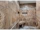 Modern walk-in shower featuring marble-patterned walls, mosaic tile accents, a built-in seat, and a shower niche at 1957 Prairie Dunes N Cir, Lakeland, FL 33810