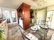 Bright dining area featuring a chandelier, a glass table setting, and views to the outside through white french doors at 2015 E Beacon By Way, Lakeland, FL 33803