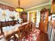 Traditional dining room with hardwood floors, a floral rug, and a carved wood table with seating for six at 2015 E Beacon By Way, Lakeland, FL 33803